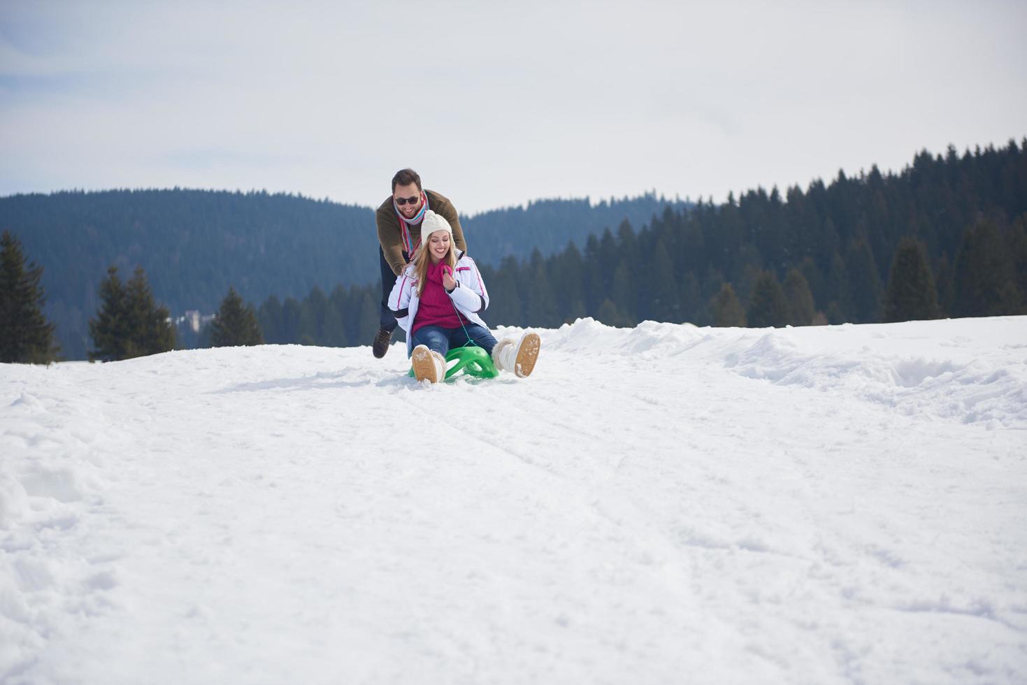 happy young couple having fun on fresh show on winter vacation photo