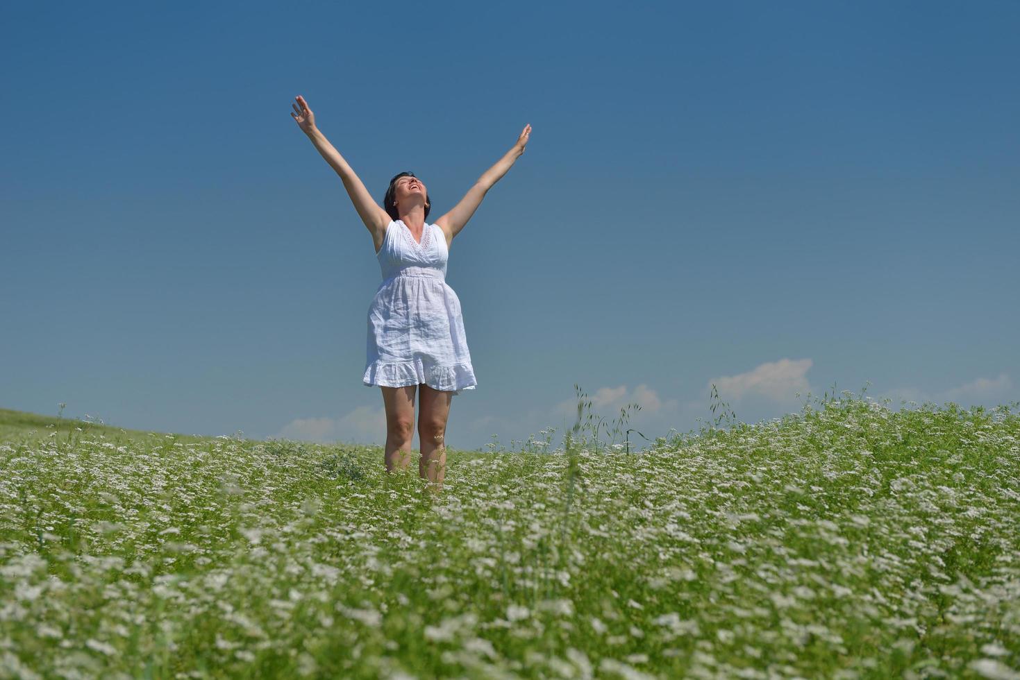 Young happy woman in green field photo