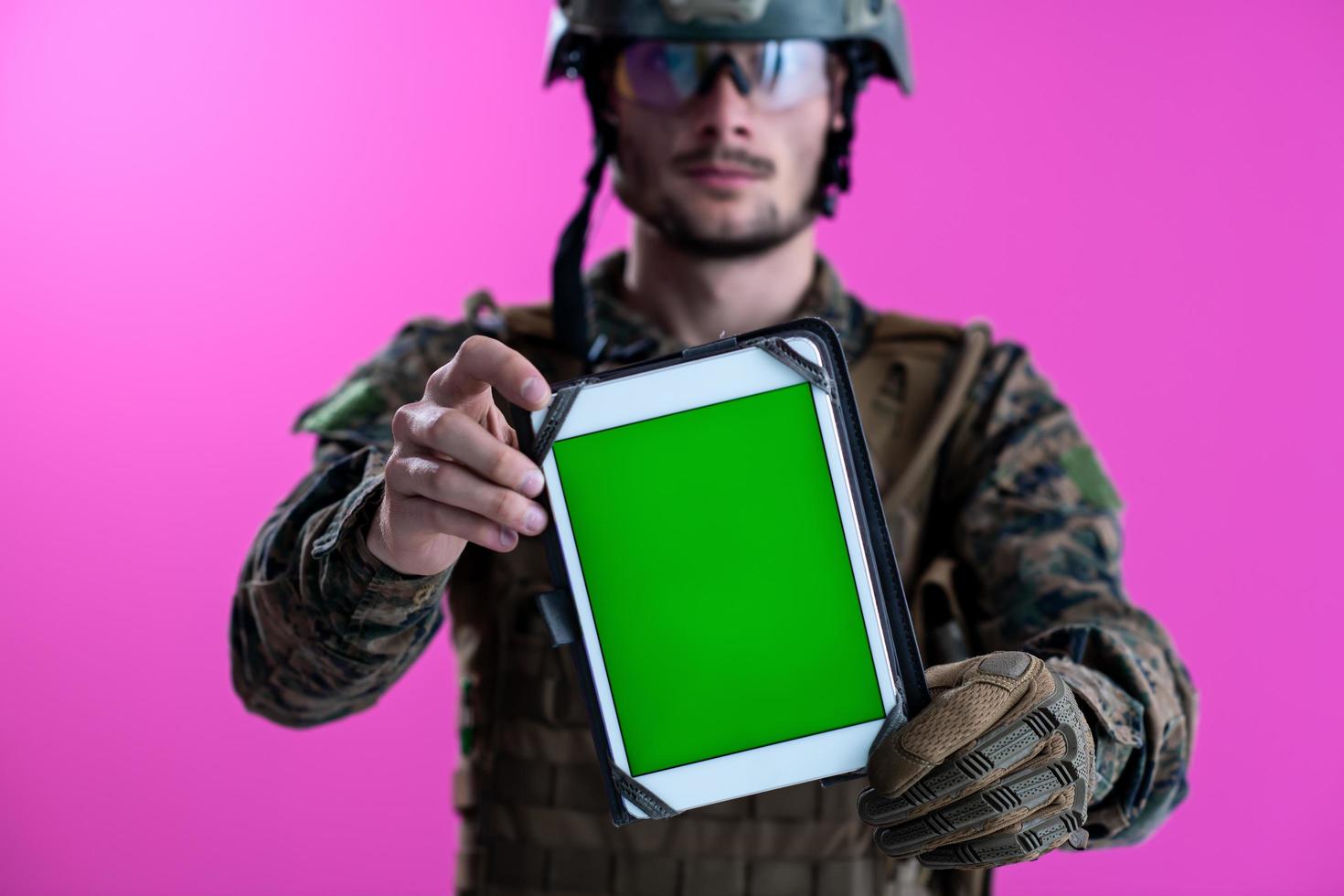 soldier showing a tablet with a blank green screen photo