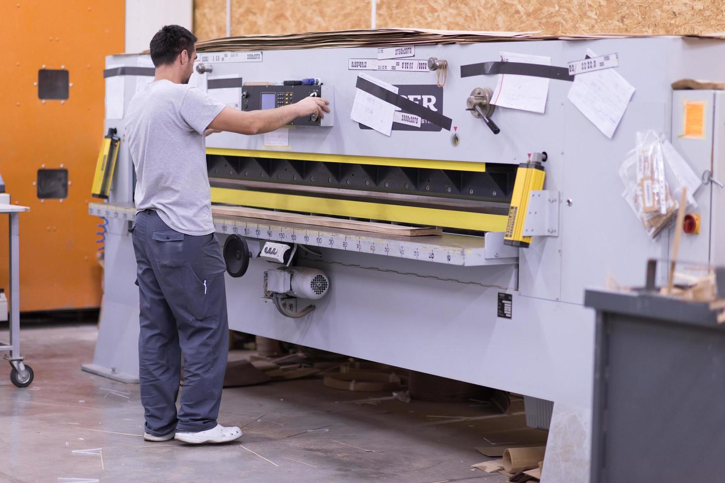 worker in a factory of wooden furniture photo