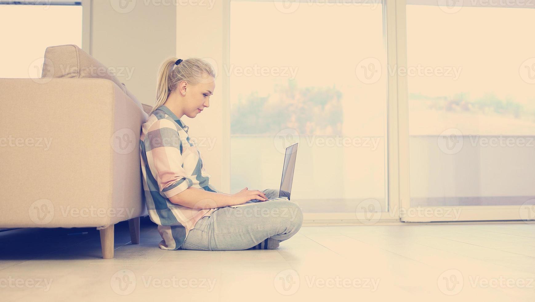 young women using laptop computer on the floor photo