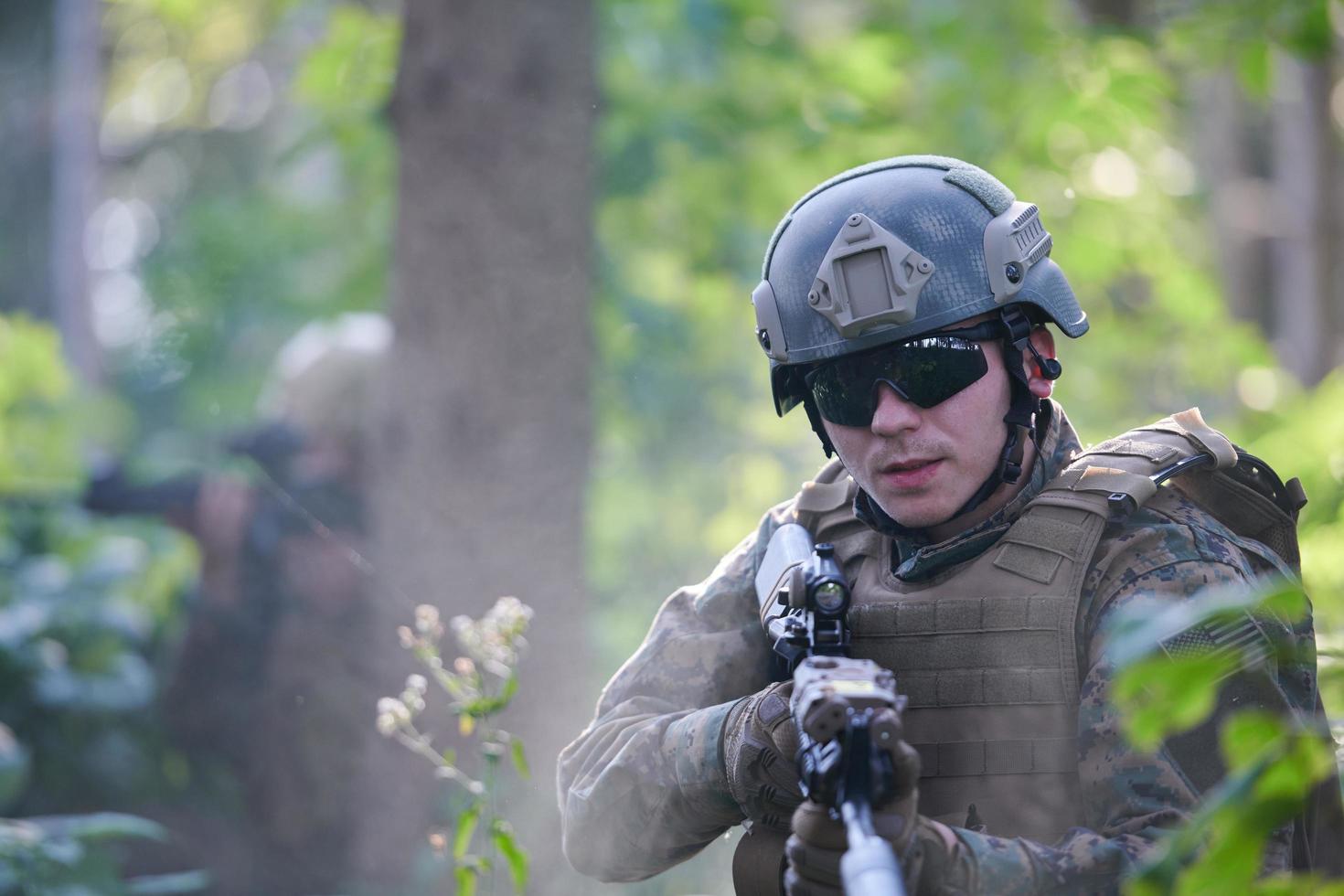 soldier in action aiming  on weapon  laser sight optics photo