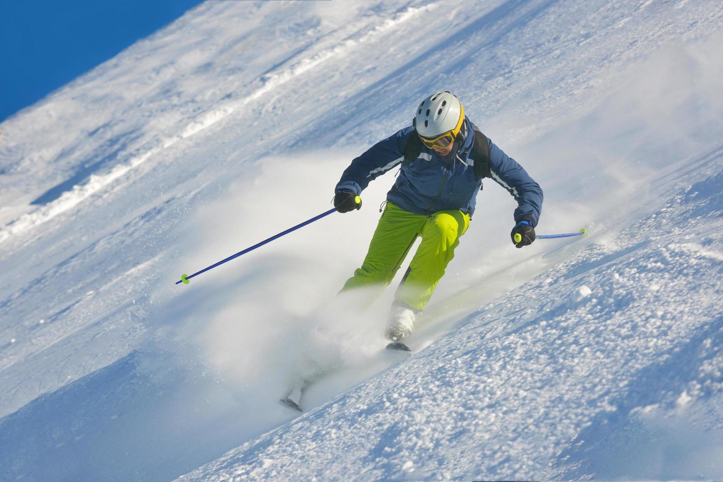 skiing on fresh snow at winter season at beautiful sunny day photo