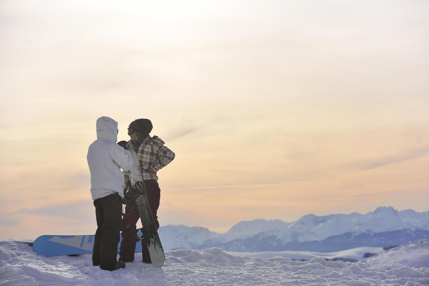 snowboarder's couple on mountain's top photo