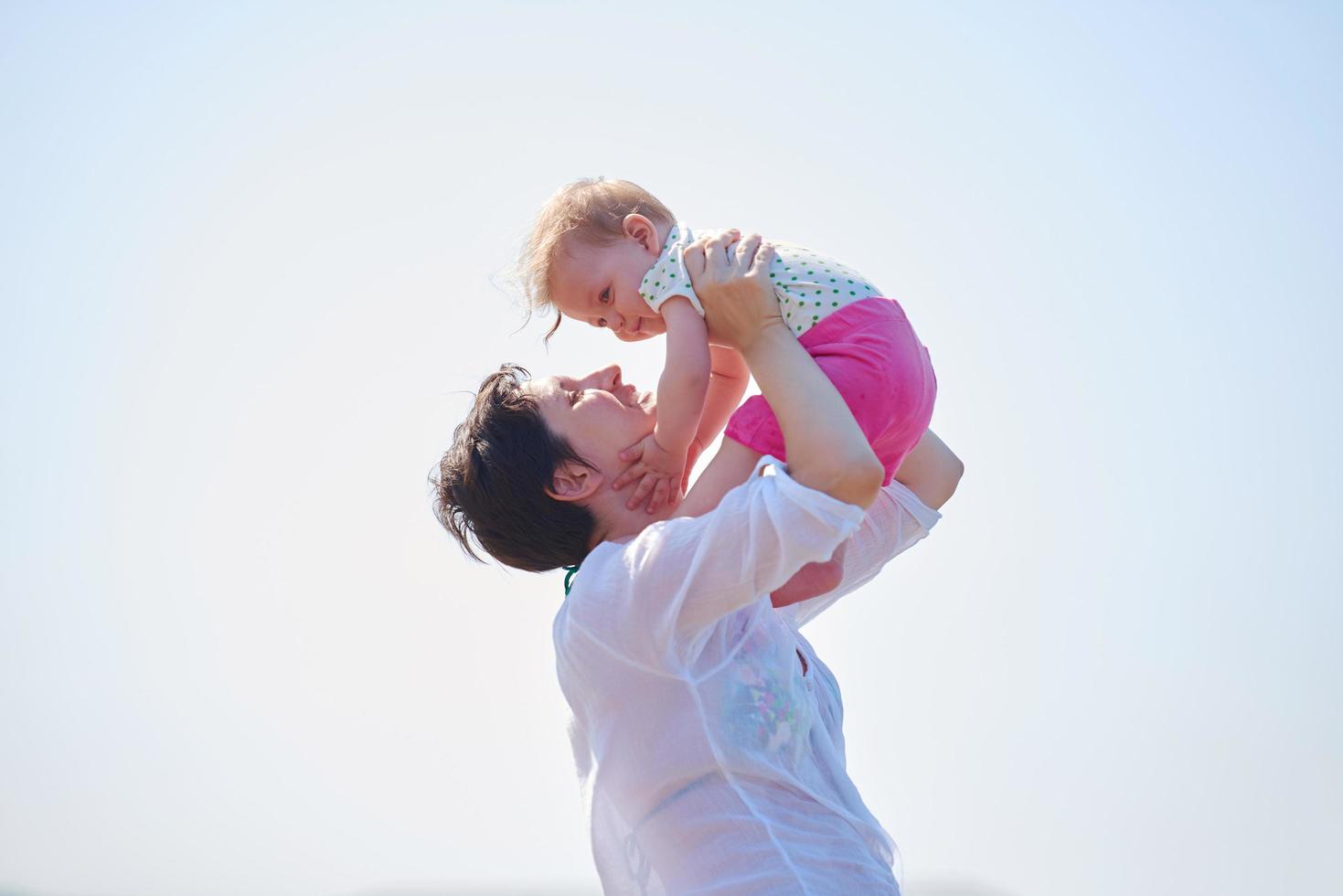 mom and baby on beach  have fun photo