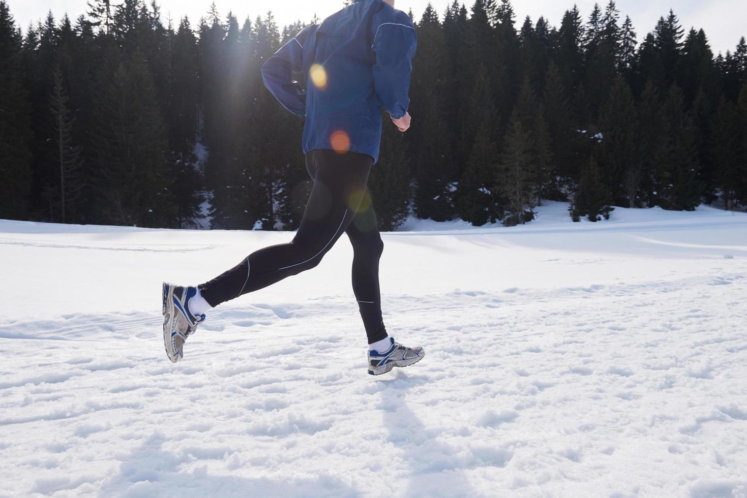 jogging on snow in forest photo