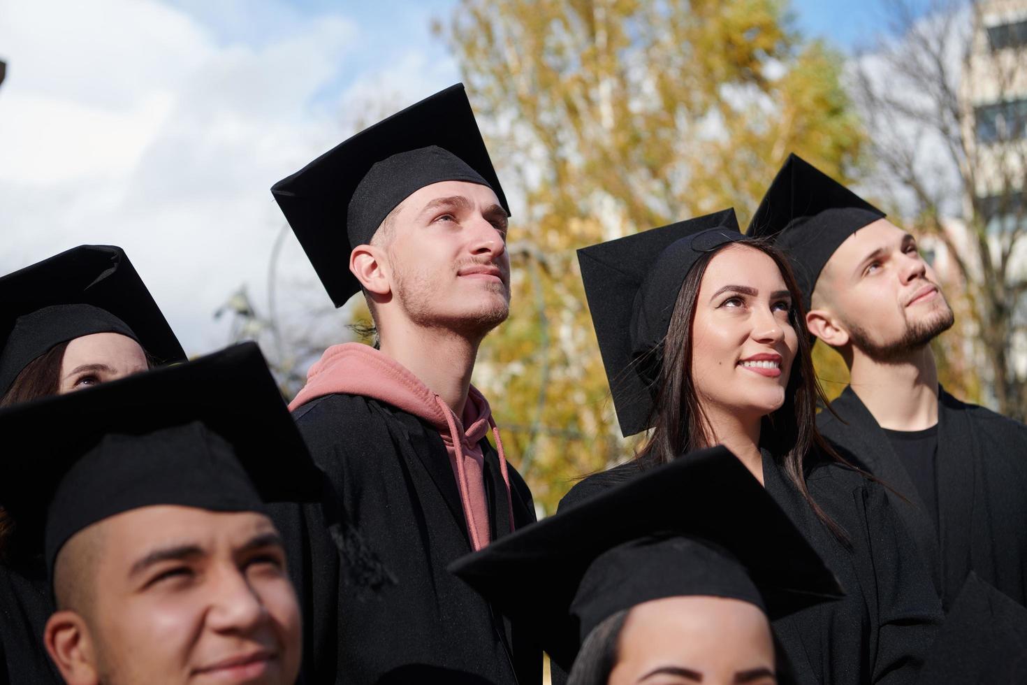 Group of diverse international graduating students celebrating photo