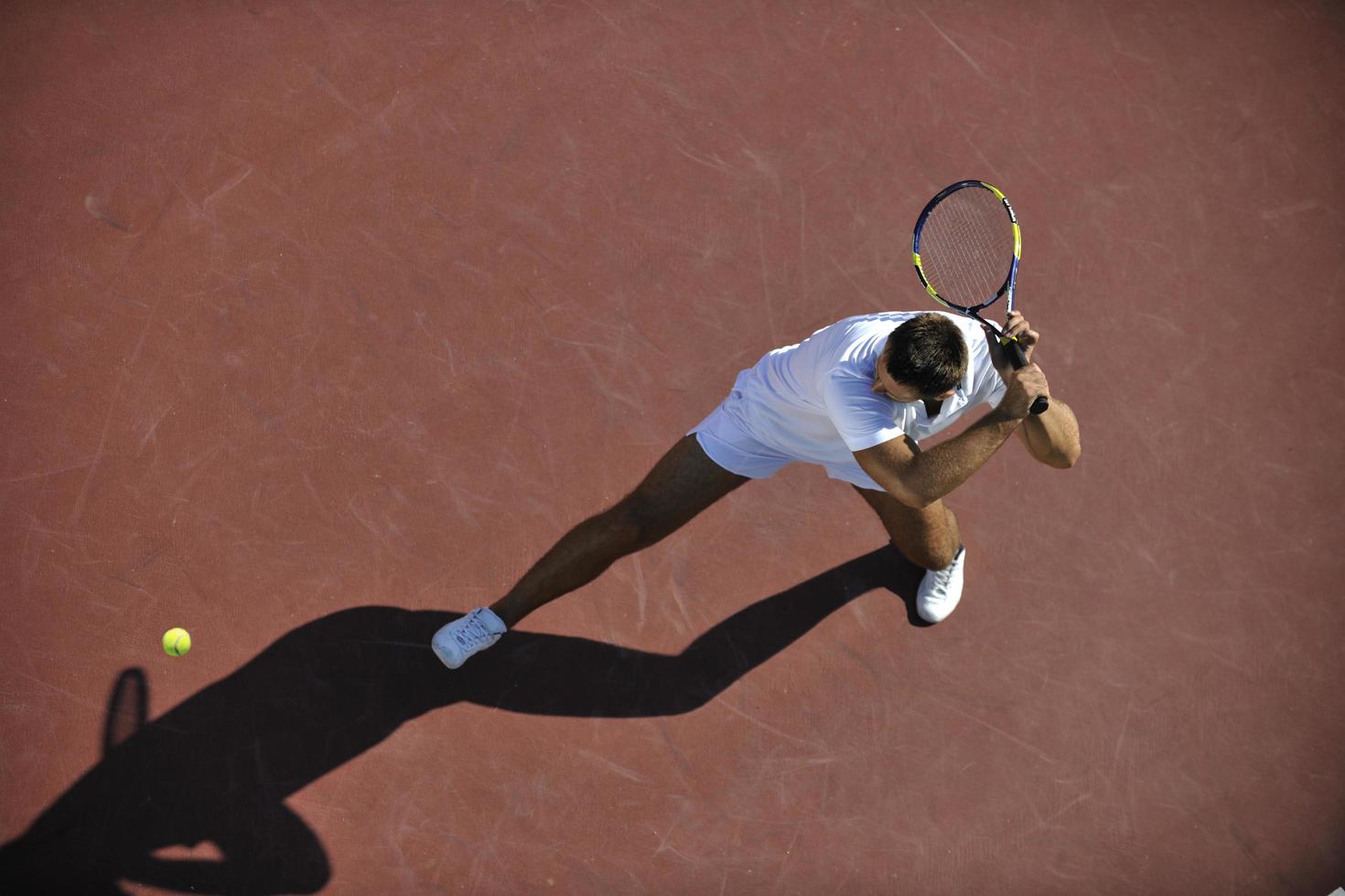 young man play tennis outdoor photo