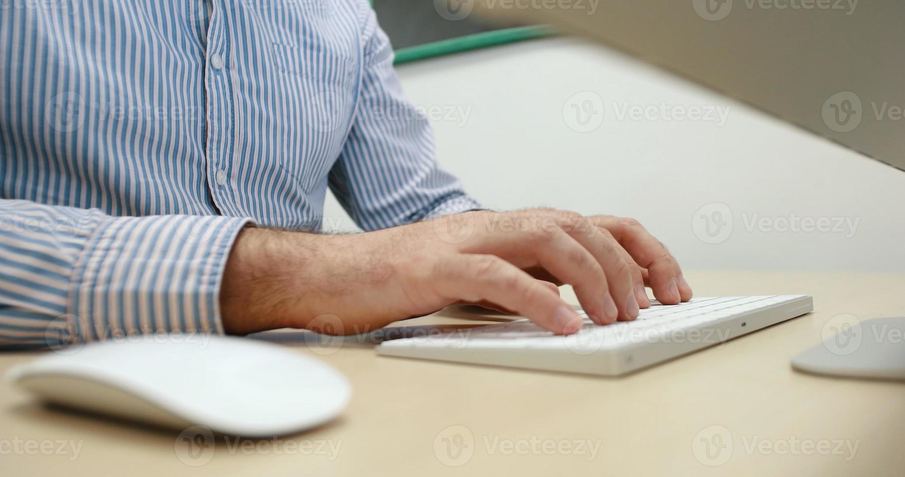 hands typing on computer keyboard in startup office photo