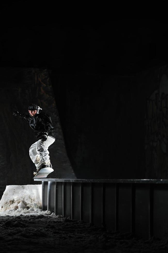 freestyle snowboarder jump in air at night photo