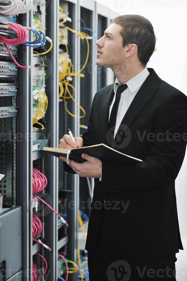 businessman withnotebook in network server room photo