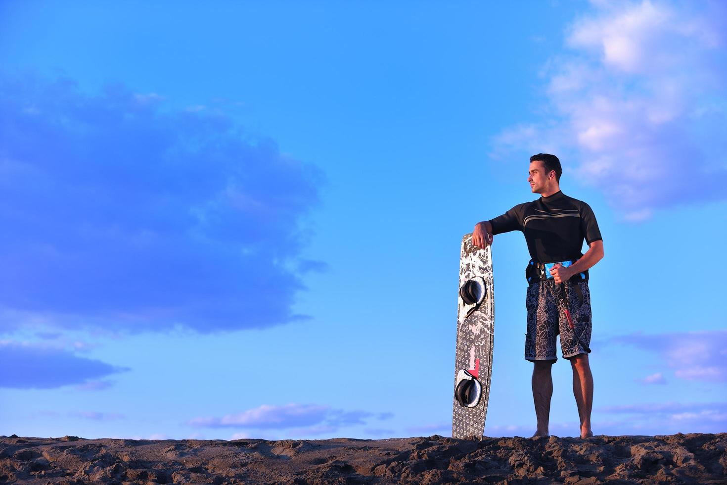 Portrait of a young  kitsurf  man at beach on sunset photo