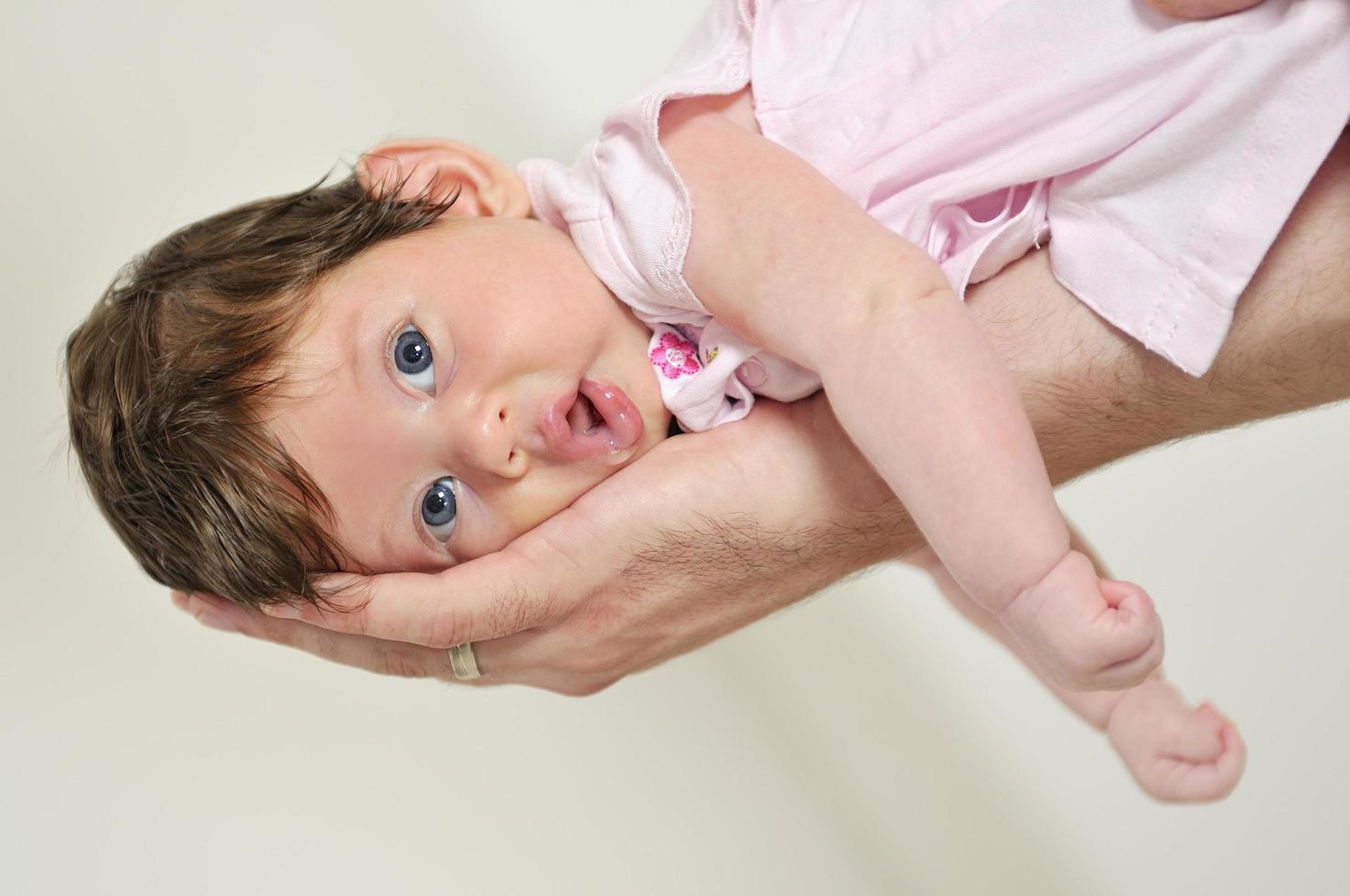 man hold little baby in hand photo