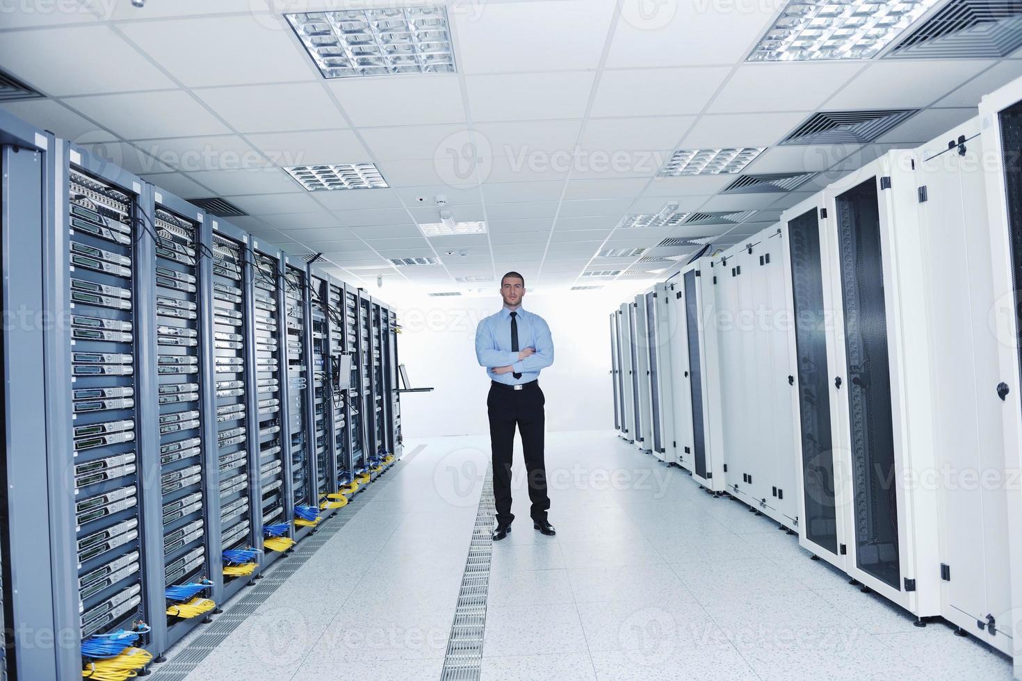 young it engineer in datacenter server room photo