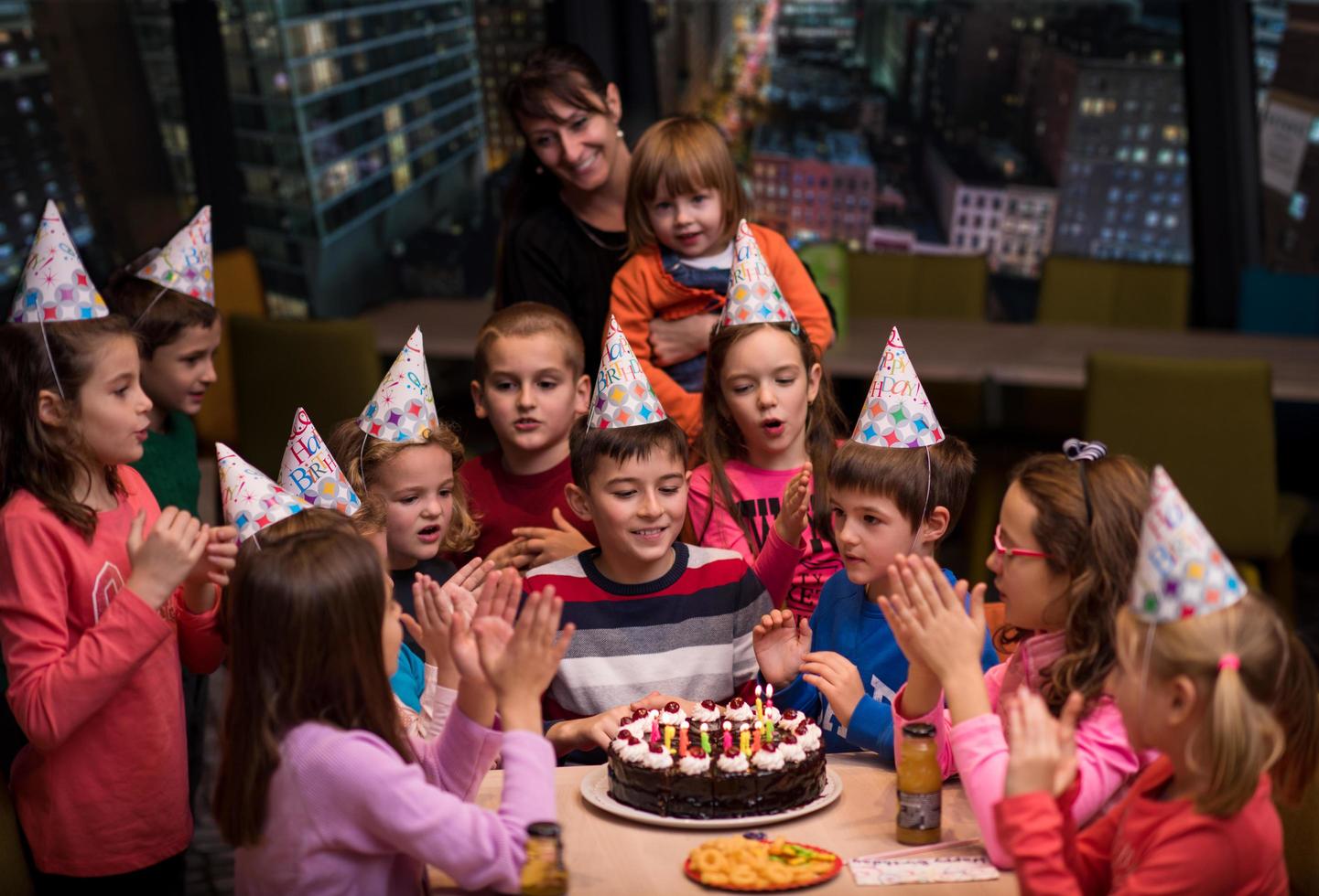 happy young boy having birthday party photo