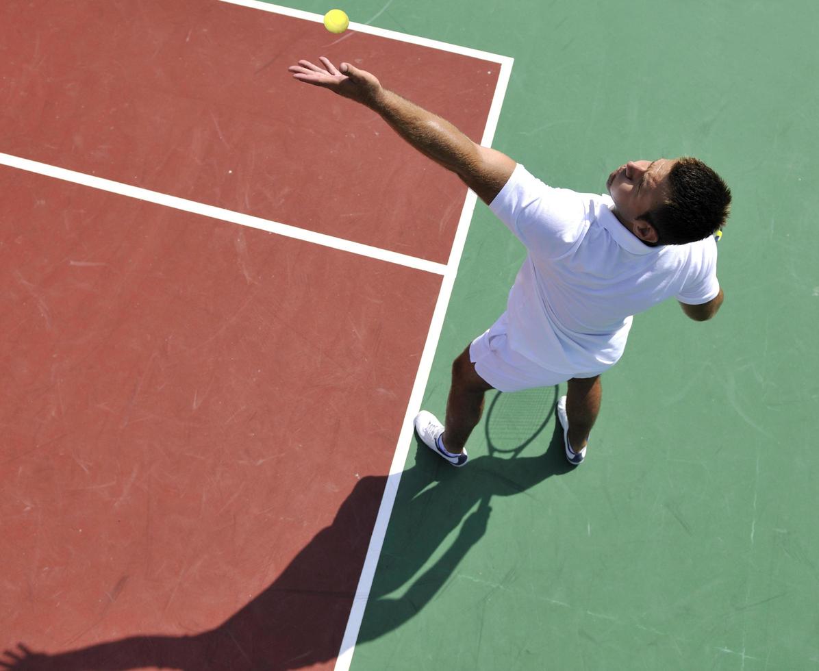 joven jugar al tenis al aire libre foto