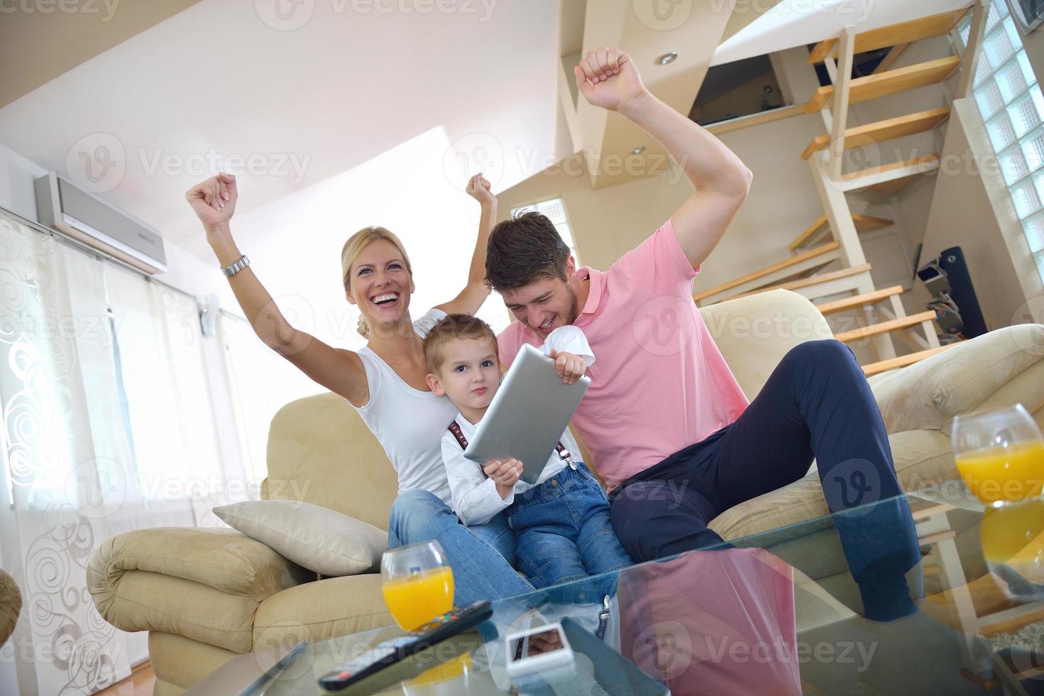 family at home using tablet computer photo