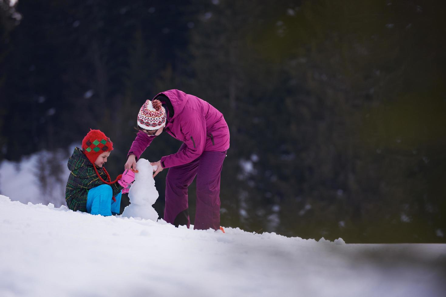 happy family building snowman photo
