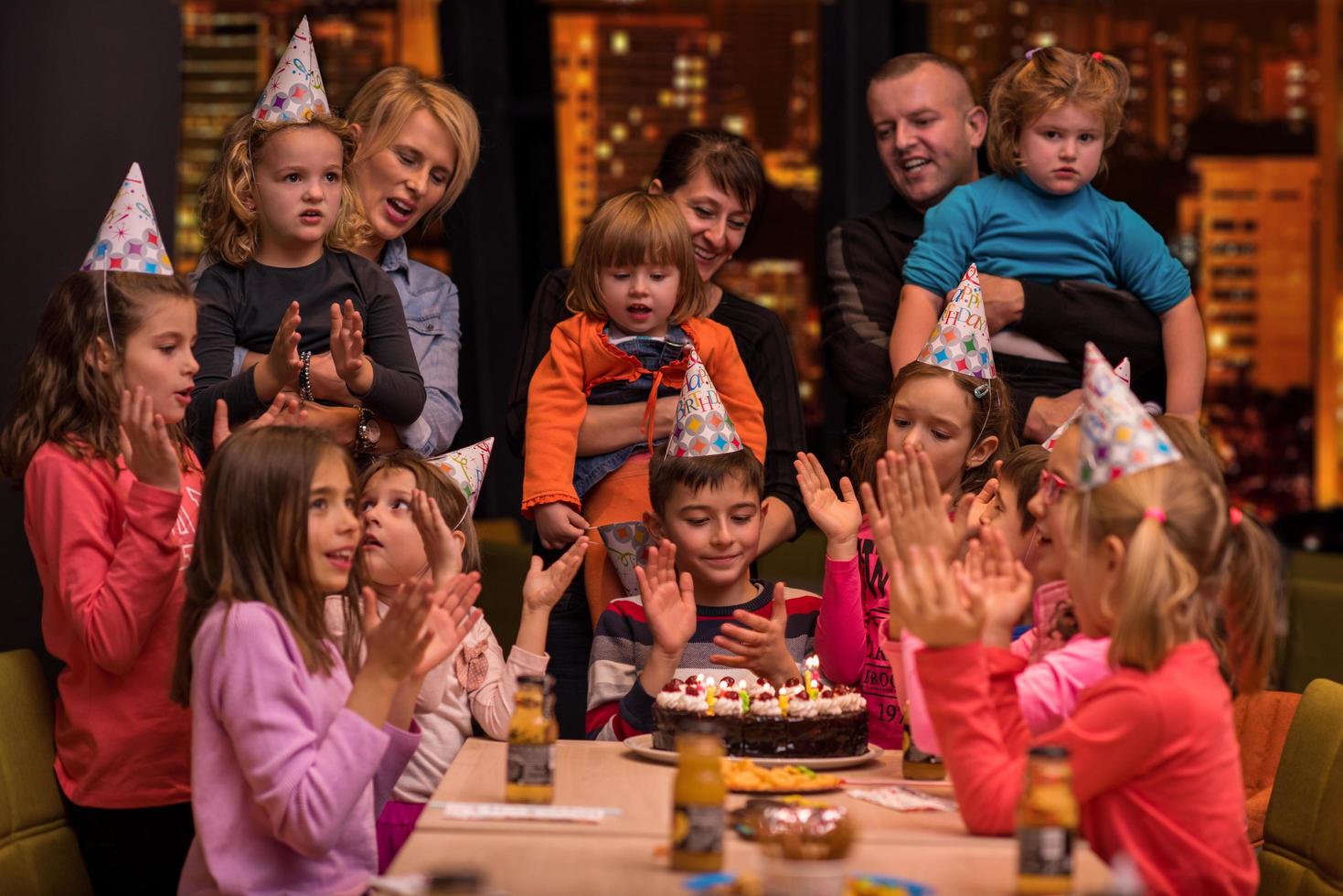 happy young boy having birthday party photo