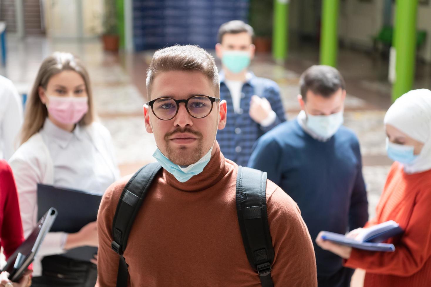 Portrait of multiethnic students group at university wearing protective face mask photo