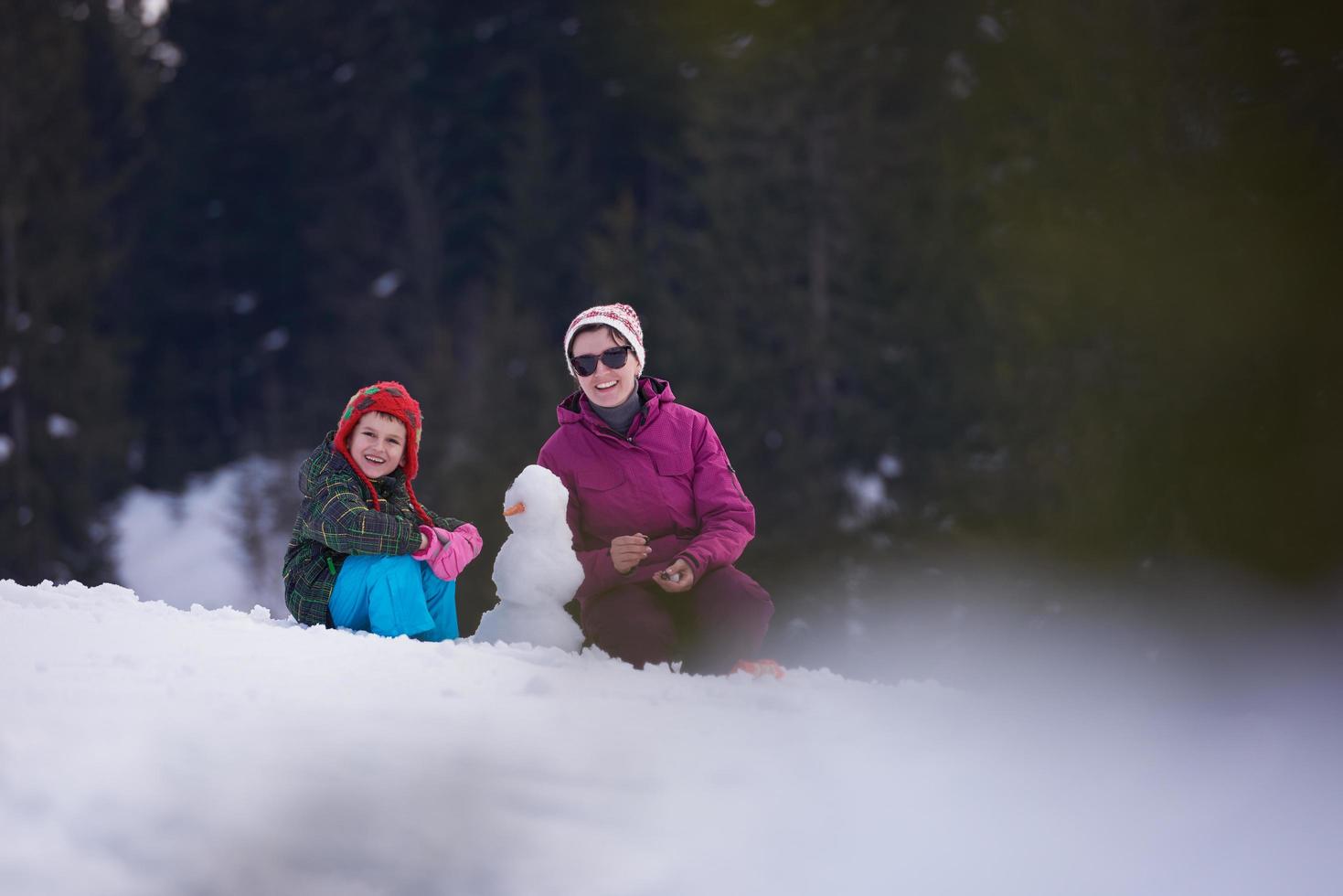 happy family building snowman photo