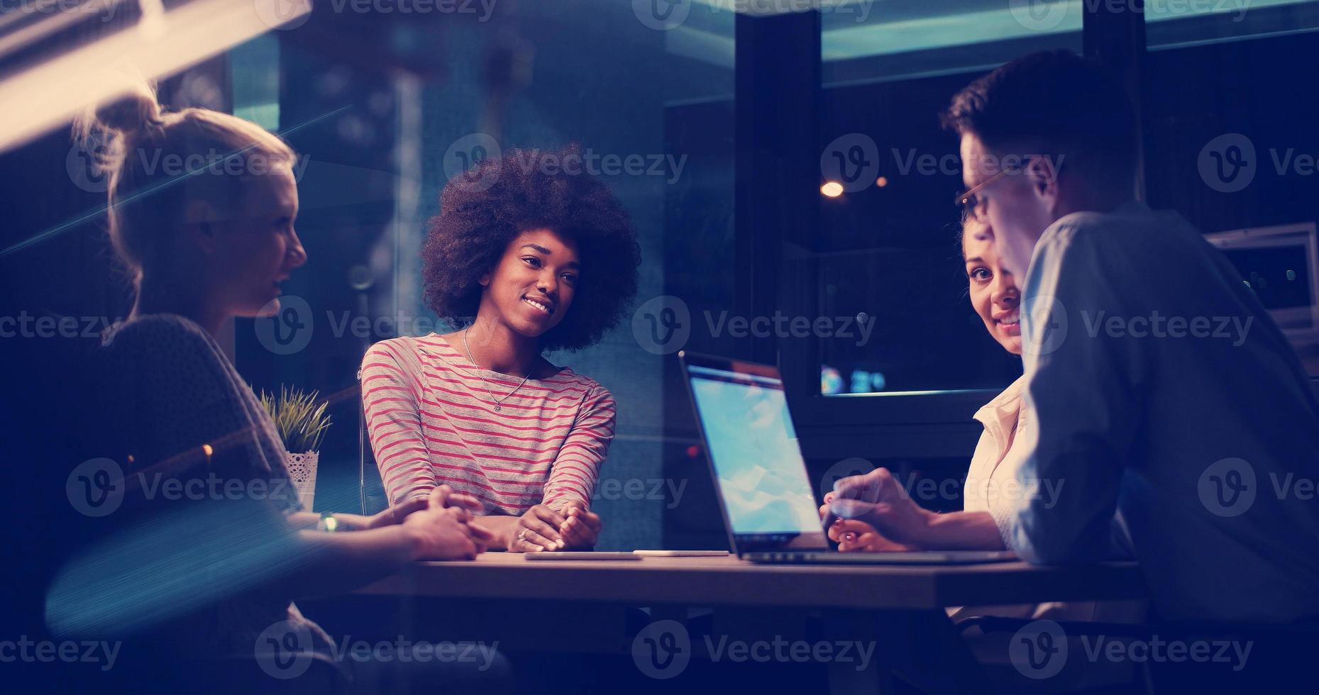 Multiethnic startup business team in night office photo