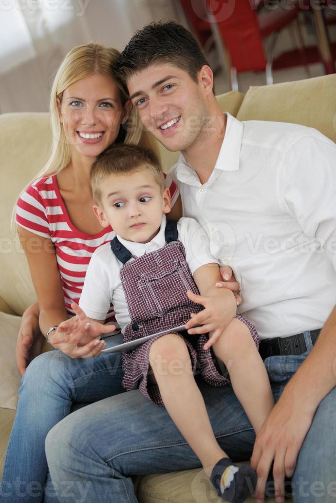 family at home using tablet computer photo