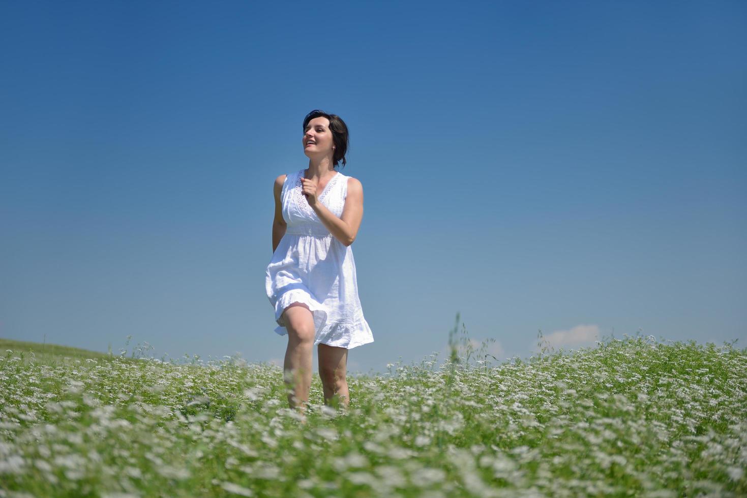 Young happy woman in green field photo