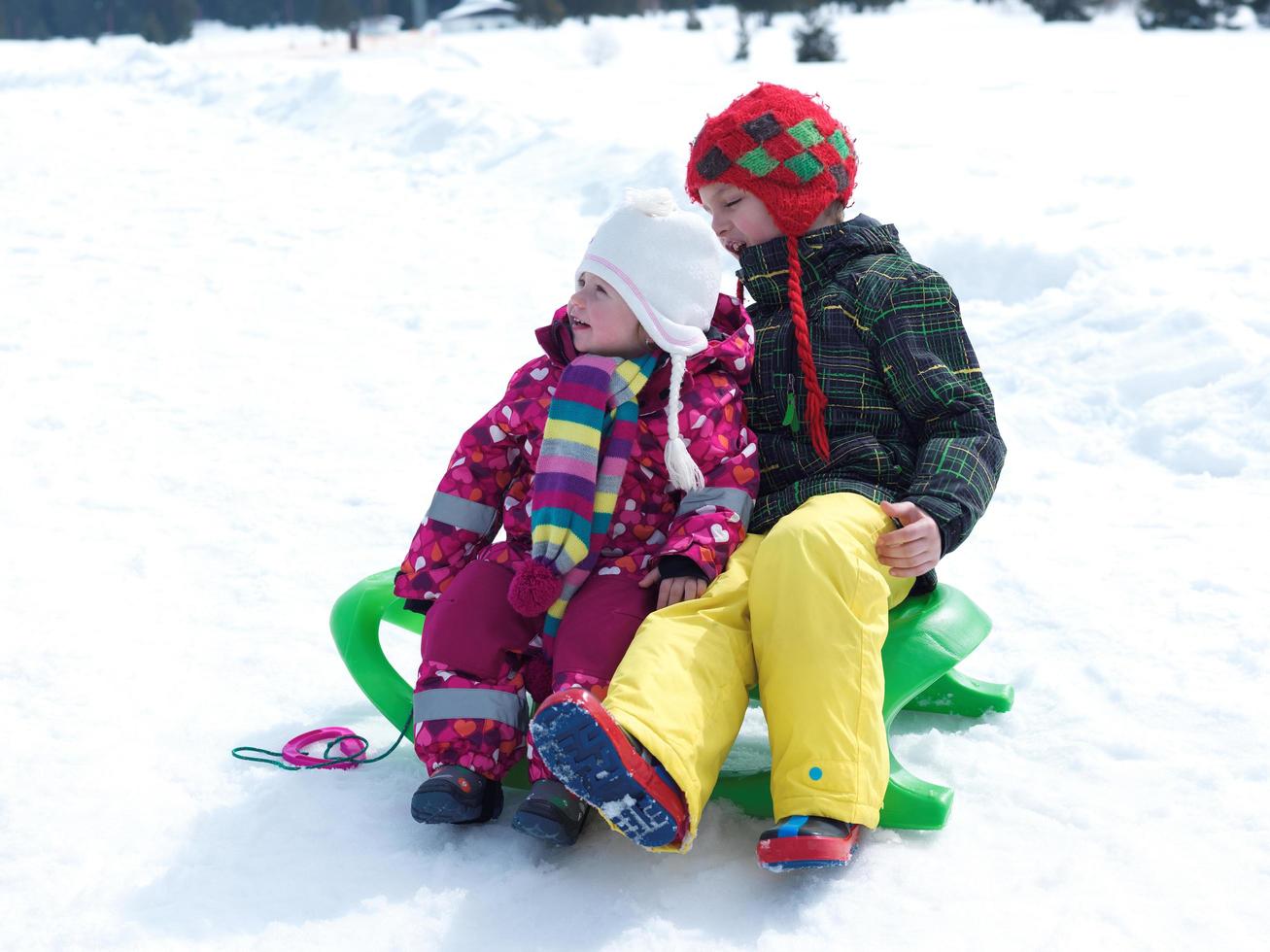 portrait of boy and baby girl on winter vacation photo