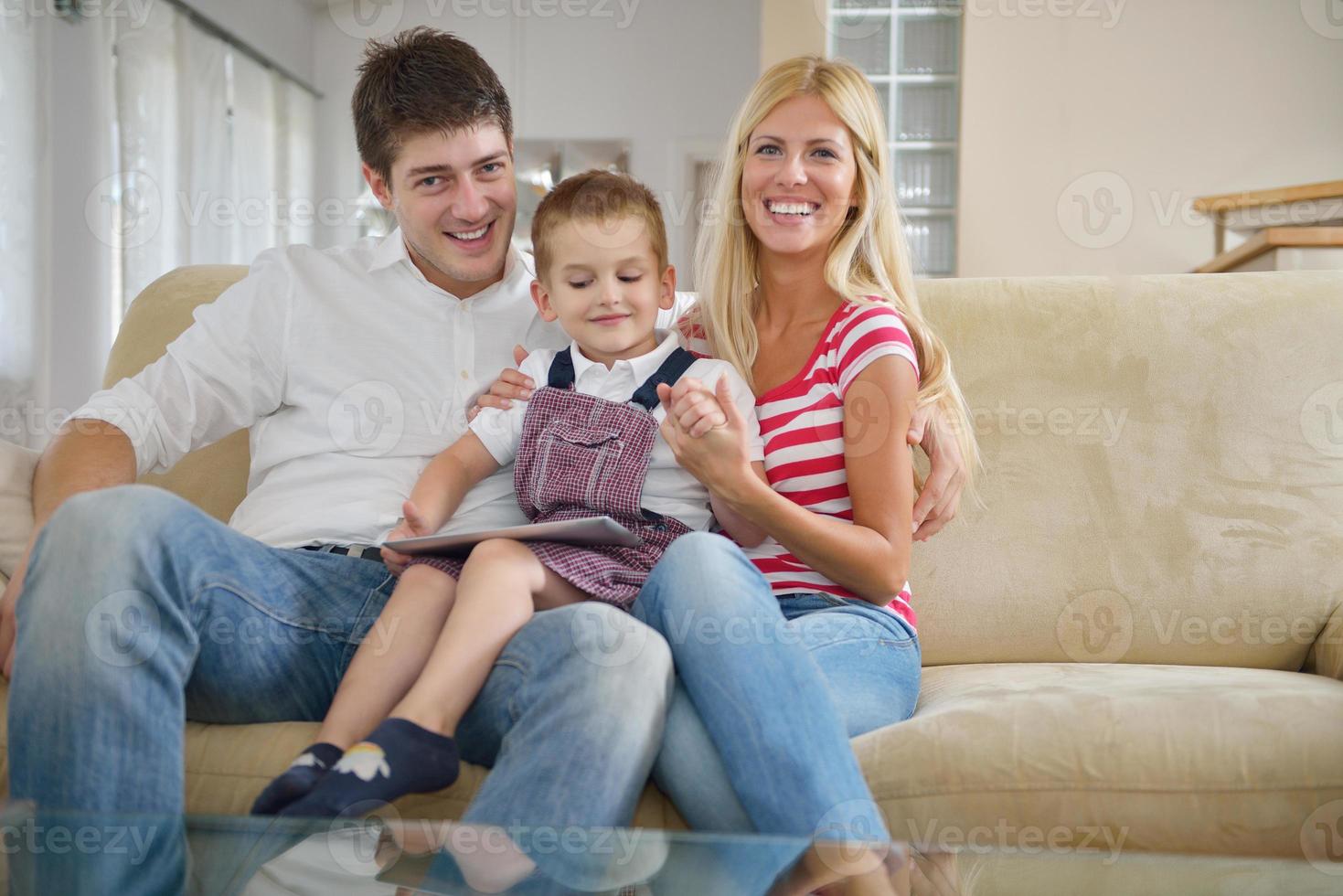 family at home using tablet computer photo