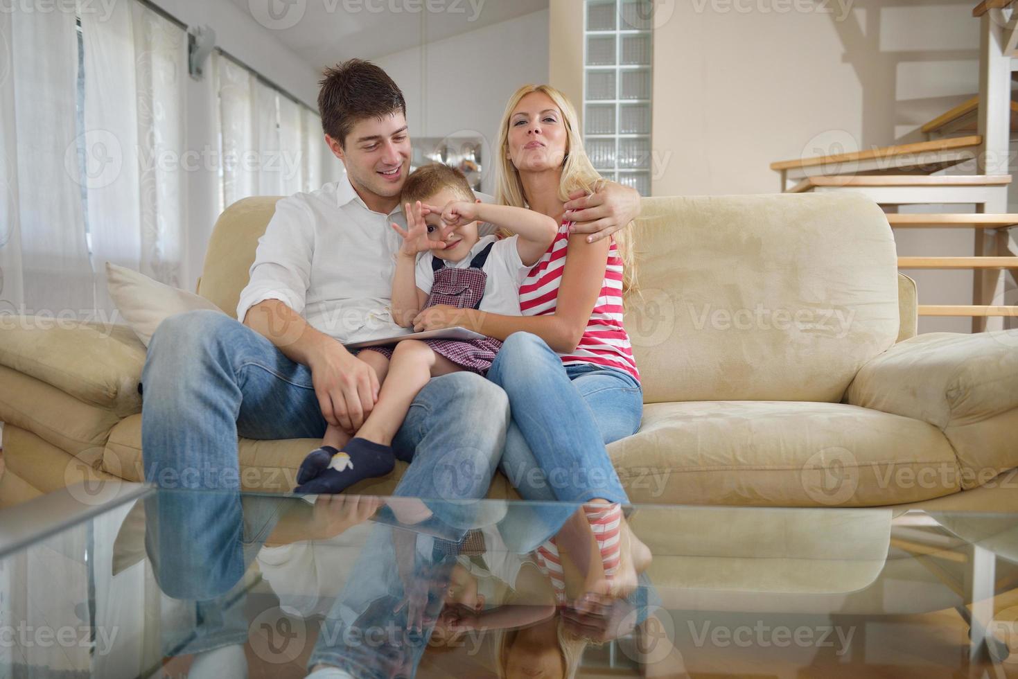 family at home using tablet computer photo