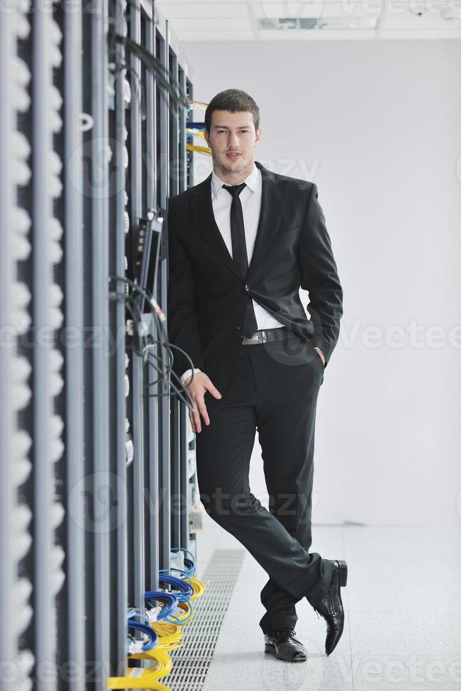 young engeneer in datacenter server room photo