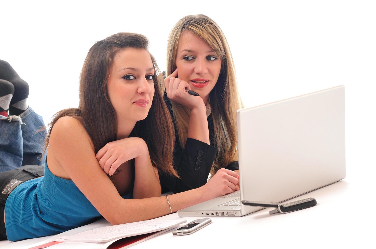 dos chicas jóvenes trabajan en una laptop aislada foto