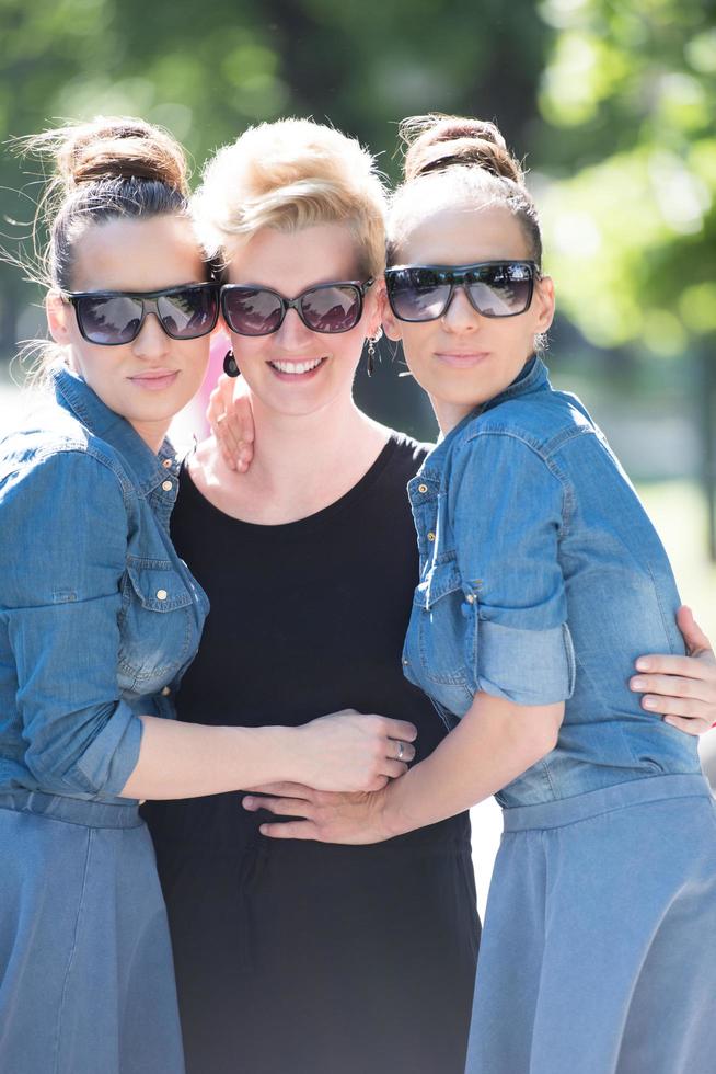 portrait of three young beautiful woman with sunglasses photo