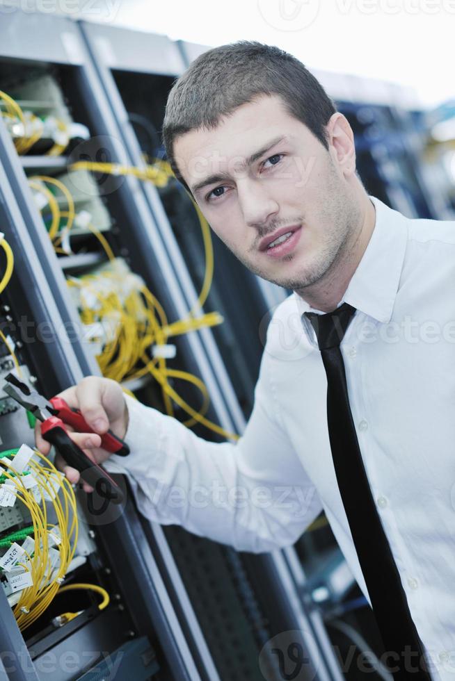 young engeneer in datacenter server room photo