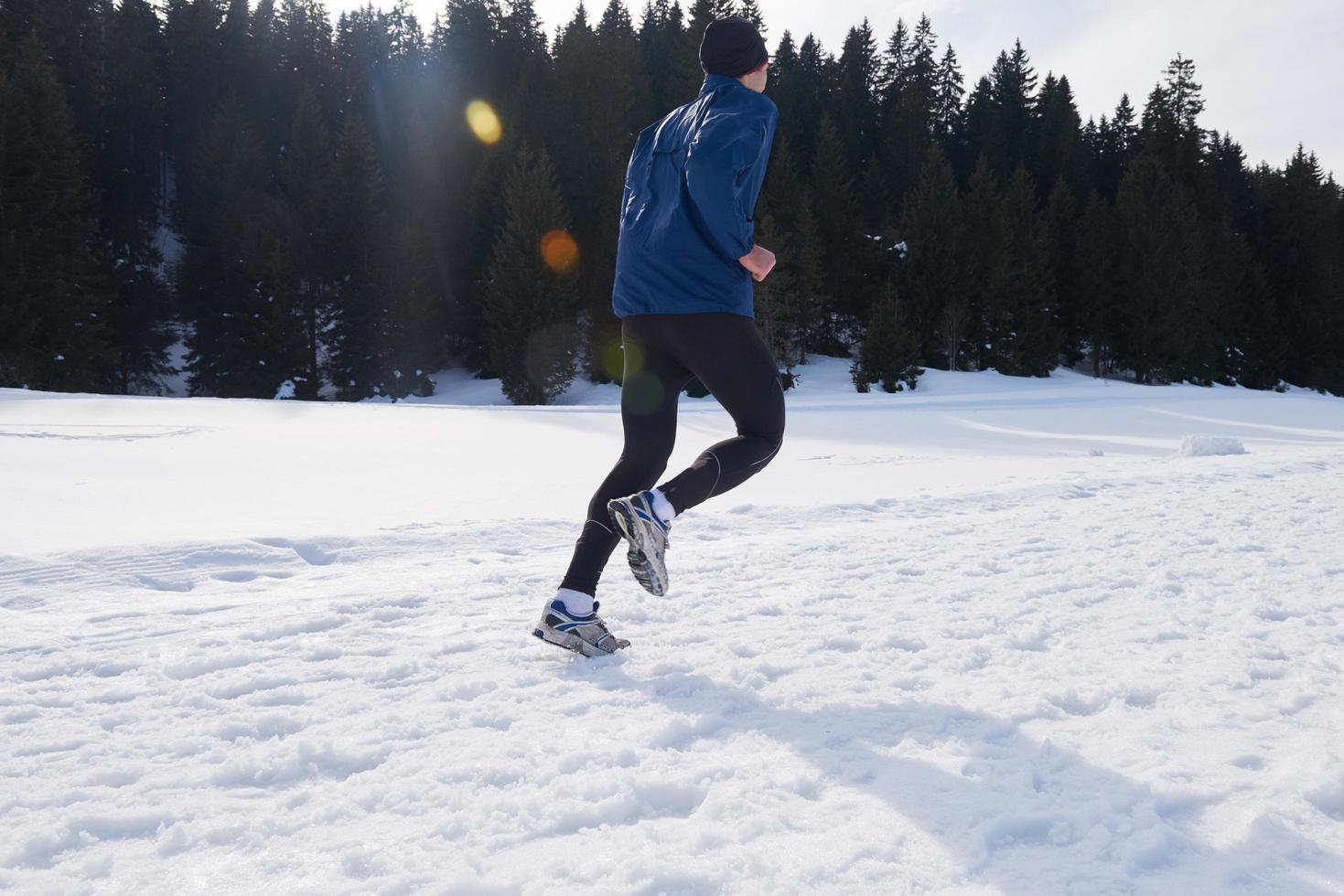 jogging on snow in forest photo
