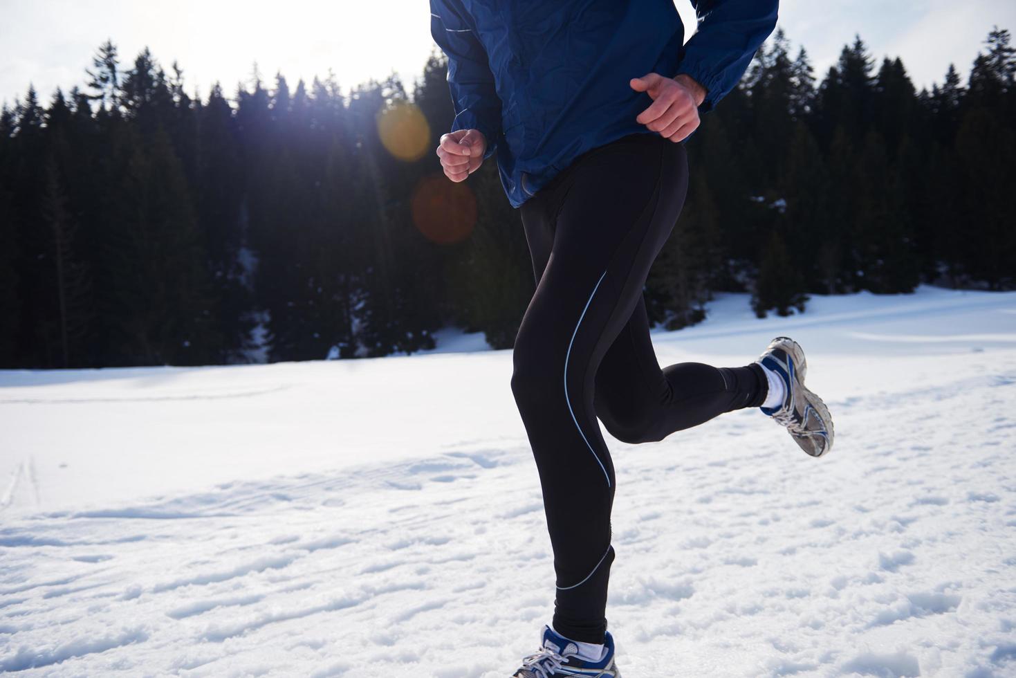 jogging on snow in forest photo