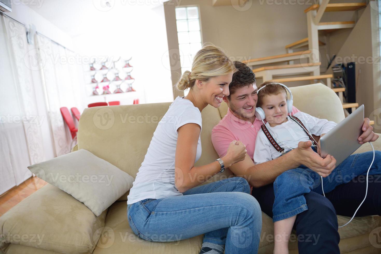 family at home using tablet computer photo