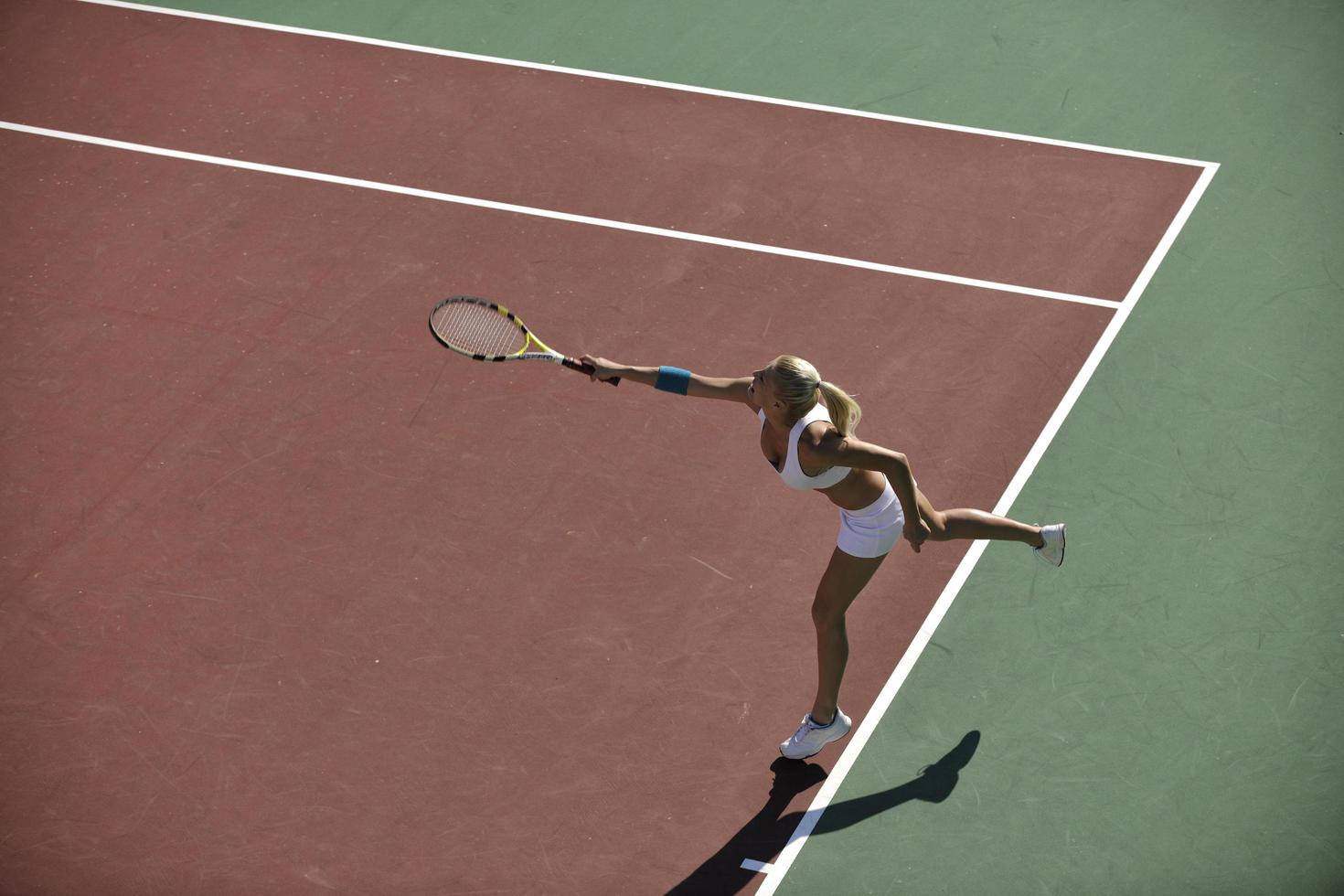 young woman play tennis outdoor photo
