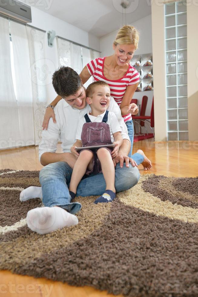 family at home using tablet computer photo