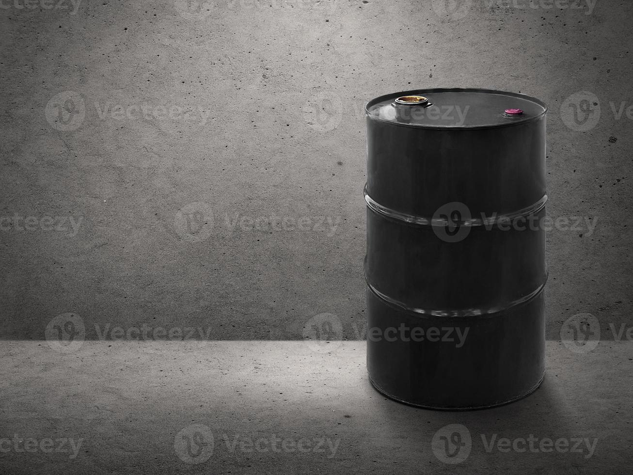 Black oil tank on cement wall background photo