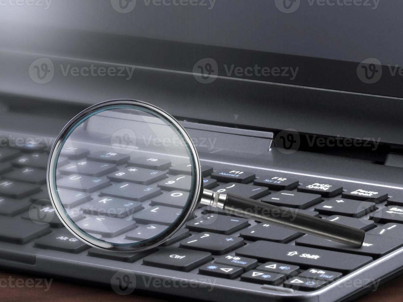 laptop computer with magnifying glass search concept photo