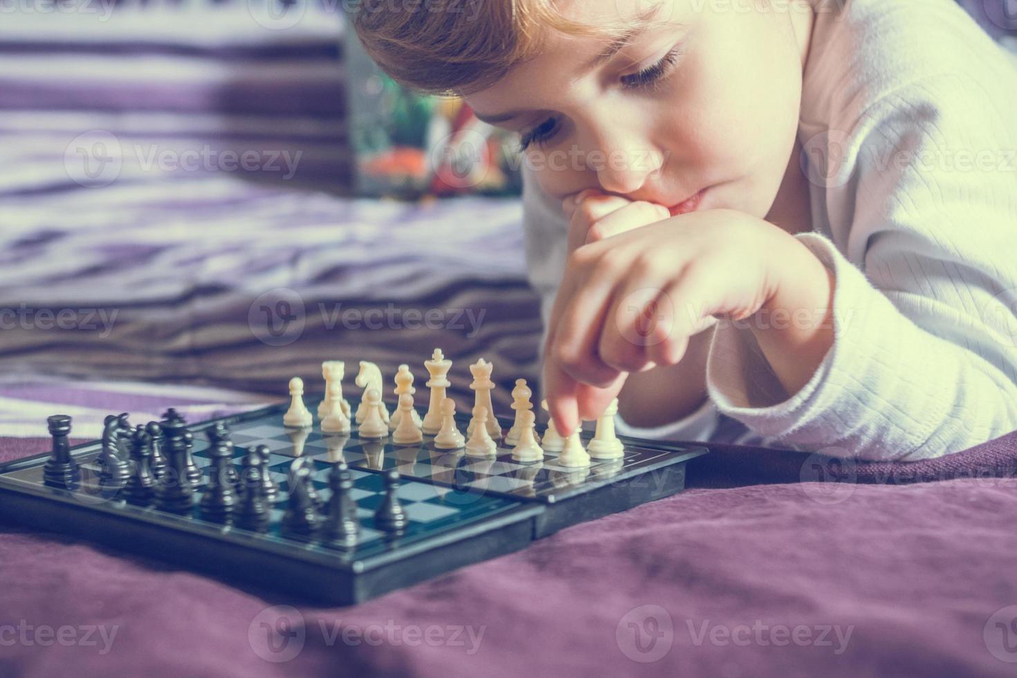 Small boy playing chess. photo