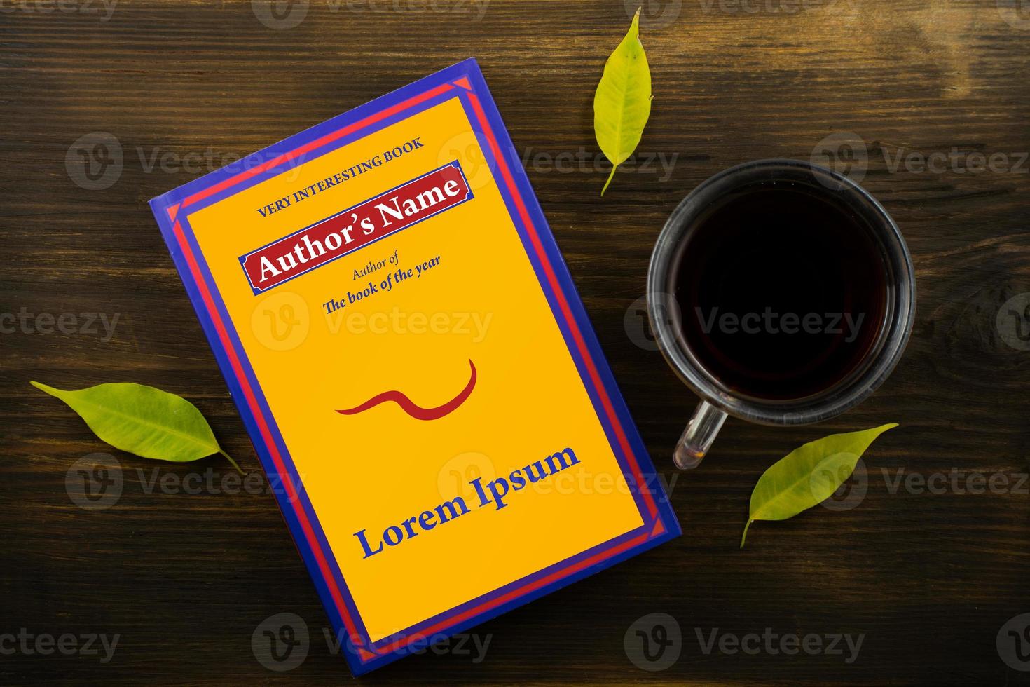 Coffee and book with bright leaves on wood background photo
