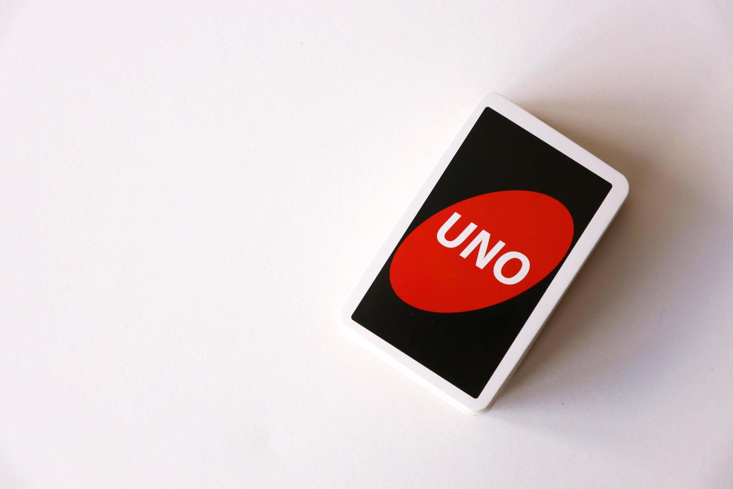 Ternopil, Ukraine - May 8, 2022 Many colorful UNO game cards on white background. UNO is an American shedding-type card game that is played with a specially printed deck photo