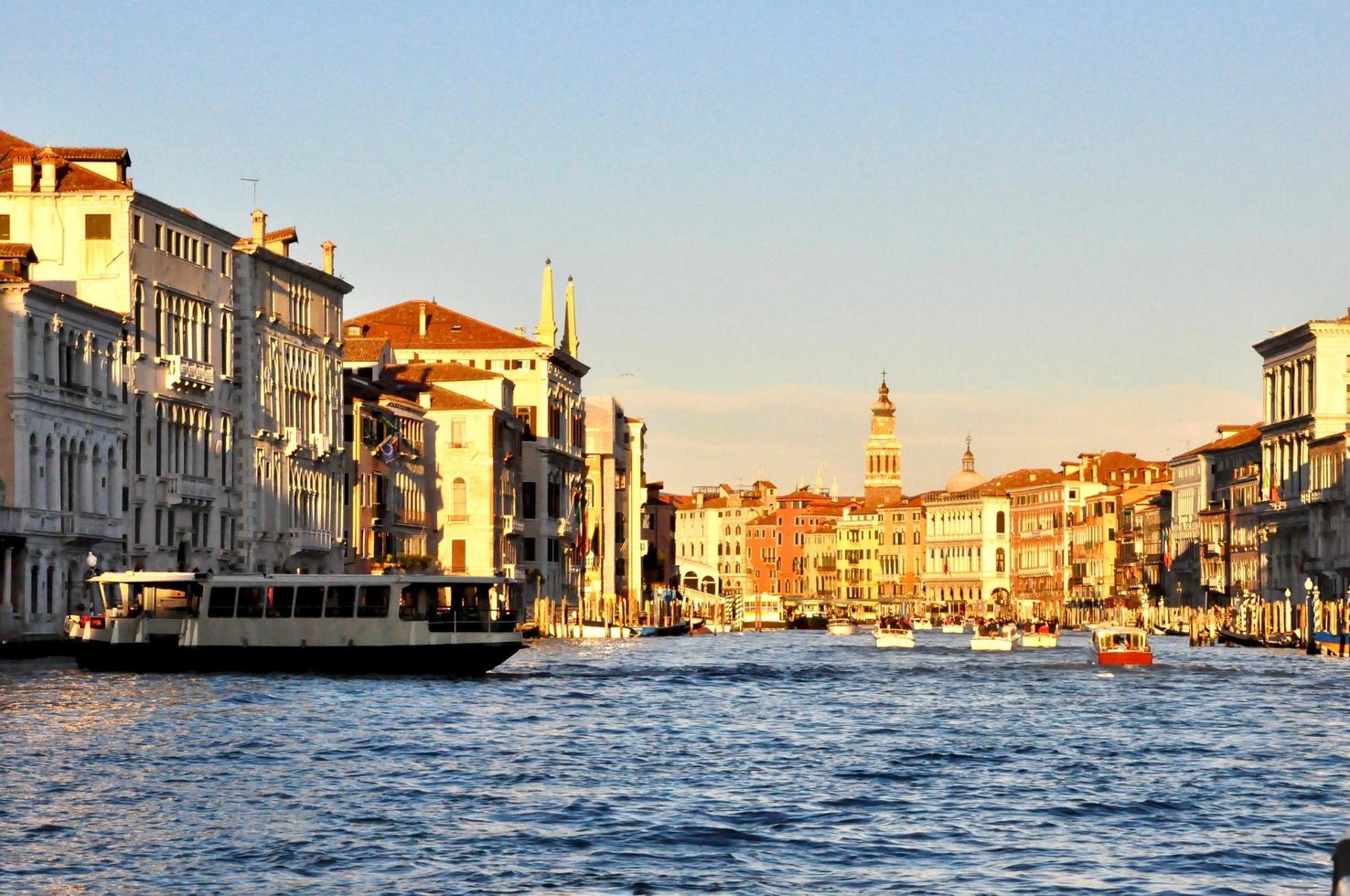 Classic Venice channel view with typical buildings, colorful windows, bridges and boats photo