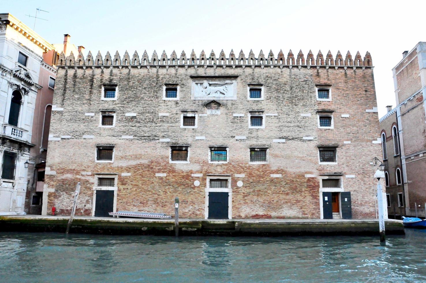 Classic Venice channel view with typical buildings, colorful windows, bridges and boats photo