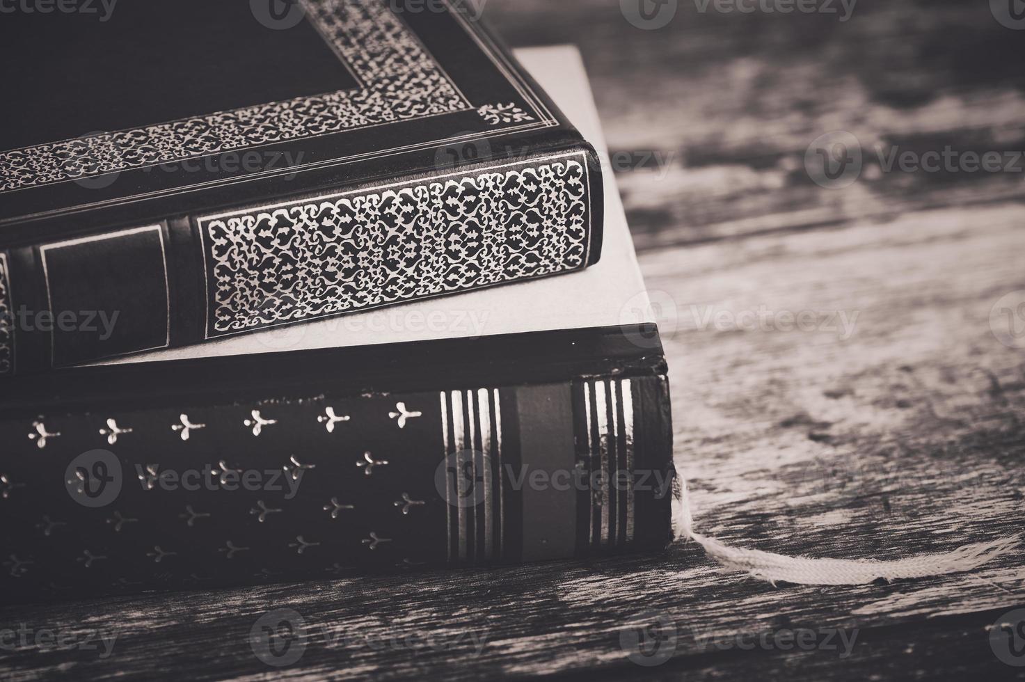 two old books on wooden background in a brown vintage style photo