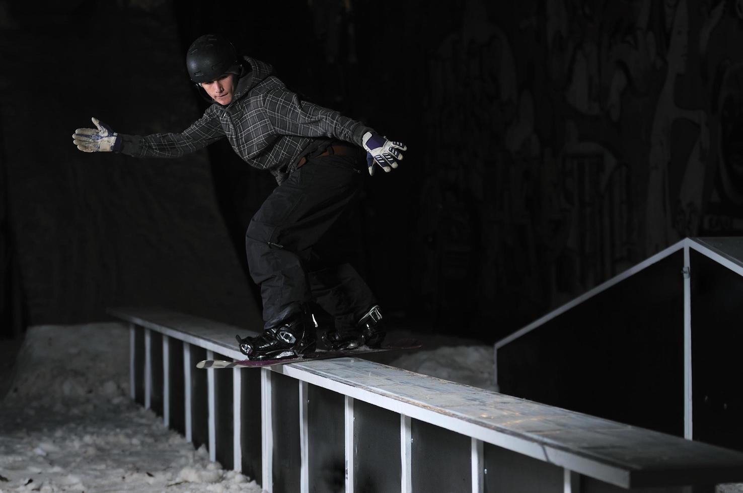 freestyle snowboarder jump in air at night photo