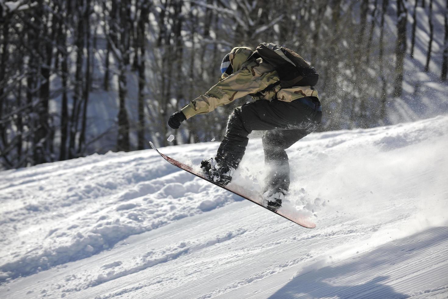 freestyle snowboarder jump and ride photo